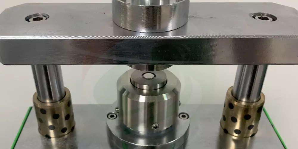 A CR1016 coin cell being crimped in the TOB-DF-160 die
