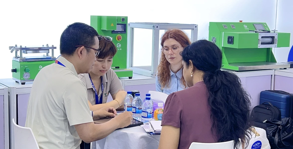 TOB NEW ENERGY technical team demonstrating battery laboratory equipment to international clients